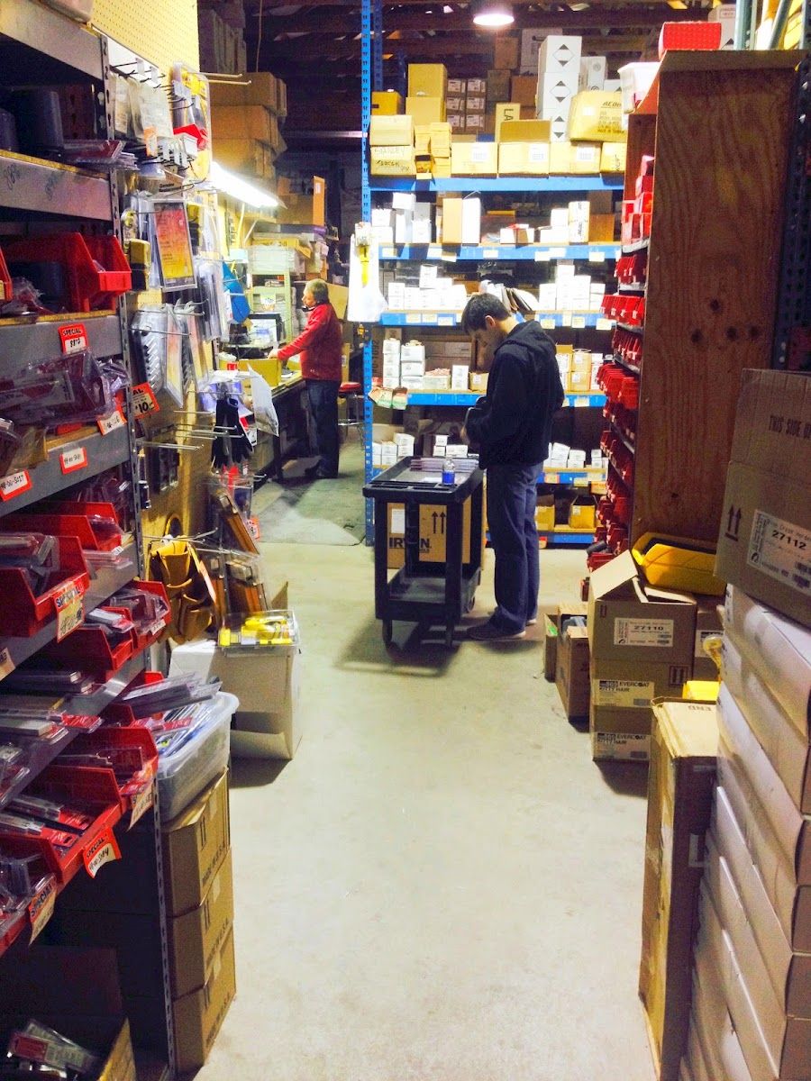Staff member working an aisle of fastener bins