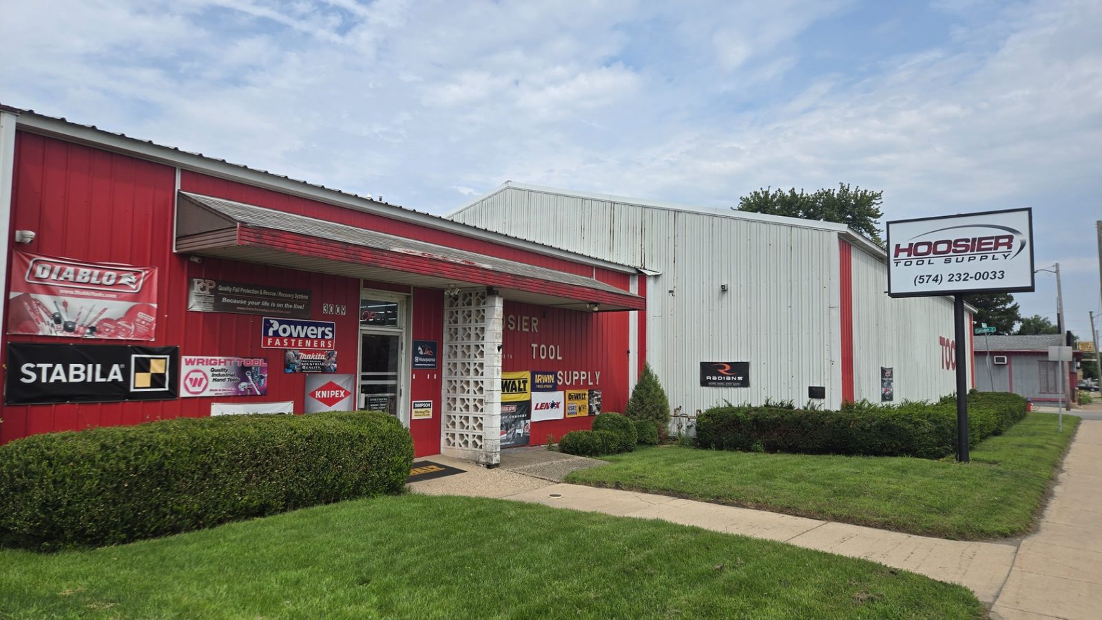The Hoosier Tool Supply building at 3009 W Sample Street in South Bend, Indiana, with the roadside sign showing (574) 232-0033